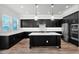 Modern kitchen featuring dark cabinets, a white center island, and stainless steel appliances at 3830 E Appaloosa Rd, Gilbert, AZ 85296