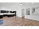 Open-concept living area with hardwood floors, a kitchen island, and modern fixtures at 3830 E Appaloosa Rd, Gilbert, AZ 85296