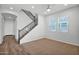 Bright living room with plush carpet, a ceiling fan, and staircase access at 3830 E Appaloosa Rd, Gilbert, AZ 85296
