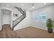 Living room with carpet and wood flooring leading to staircase and entrance at 3830 E Appaloosa Rd, Gilbert, AZ 85296
