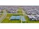 Aerial view of tennis courts surrounded by lush green spaces, offering a great amenity within a vibrant residential community at 3830 E Appaloosa Rd, Gilbert, AZ 85296