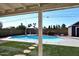 A luxurious backyard featuring a sparkling pool, gazebo, artificial grass, and a privacy fence, creating an ideal outdoor oasis at 4631 W Mcrae Way, Glendale, AZ 85308