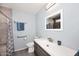 Updated bathroom with tiled shower and modern vanity at 4631 W Mcrae Way, Glendale, AZ 85308