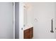 A clean half-bathroom with wood cabinets and a decorative towel rack at 4631 W Mcrae Way, Glendale, AZ 85308