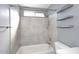 This clean bathroom features a shower/tub combo and floating shelves at 4631 W Mcrae Way, Glendale, AZ 85308