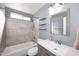 This bathroom features a shower/tub combo, floating shelves, and a modern vanity at 4631 W Mcrae Way, Glendale, AZ 85308