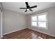 This bedroom features wood floors, a ceiling fan, and a double-paned window at 4631 W Mcrae Way, Glendale, AZ 85308