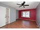 This sunny bedroom features a large window, wood floors, and a ceiling fan at 4631 W Mcrae Way, Glendale, AZ 85308