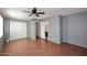 This spacious bedroom features wood floors, a ceiling fan, and access to a private bathroom at 4631 W Mcrae Way, Glendale, AZ 85308