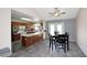 A kitchen and dining area with tile floor, island, and wooden cabinets at 4631 W Mcrae Way, Glendale, AZ 85308