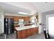 View of the kitchen with a breakfast bar island and stainless steel appliances at 4631 W Mcrae Way, Glendale, AZ 85308