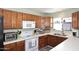 Bright kitchen with wood cabinets, stainless appliances, and a large sink at 4631 W Mcrae Way, Glendale, AZ 85308