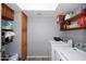 Spacious laundry room with a skylight, shelving, and washer and dryer at 4631 W Mcrae Way, Glendale, AZ 85308