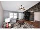 Inviting living room with a vaulted ceiling, ceiling fan, a decorative fireplace, and hardwood floors at 4631 W Mcrae Way, Glendale, AZ 85308