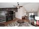 Spacious living room with a vaulted ceiling, an open layout, decorative fireplace, and hardwood floors at 4631 W Mcrae Way, Glendale, AZ 85308