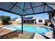 Backyard pool area with a covered patio and solar panels on the roof at 4631 W Mcrae Way, Glendale, AZ 85308
