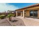 Spacious backyard with a covered patio, designed with desert landscaping, decorative rocks, and pavers at 4695 N 204Th Ave, Buckeye, AZ 85396