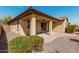 Charming backyard with covered patio, designed with desert landscaping, decorative rocks, and pavers at 4695 N 204Th Ave, Buckeye, AZ 85396