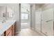 Bright bathroom with tile floors, a shower, and a view to the main bedroom at 4695 N 204Th Ave, Buckeye, AZ 85396