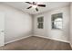 Cozy bedroom with neutral walls and carpet, ceiling fan, and windows for natural light at 4695 N 204Th Ave, Buckeye, AZ 85396