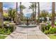 Beautiful community fountain on tiled walkway lined with palm trees and landscaping at 4695 N 204Th Ave, Buckeye, AZ 85396