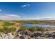 Golf course view of lush green fairways and blue lake and mountain views at 4695 N 204Th Ave, Buckeye, AZ 85396