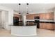 Spacious kitchen with granite countertops, cabinets, tile floors, and modern appliances at 4695 N 204Th Ave, Buckeye, AZ 85396