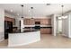 Well-lit kitchen featuring dark granite countertops, tile floors, and open layout at 4695 N 204Th Ave, Buckeye, AZ 85396