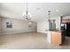 Spacious living room with tile floors, a ceiling fan, and a kitchen island at 4695 N 204Th Ave, Buckeye, AZ 85396