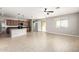 Open-concept living space with tile floors, a ceiling fan, and access to the kitchen at 4695 N 204Th Ave, Buckeye, AZ 85396
