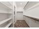 Bright walk-in closet featuring built-in shelving and hanging rods, offering ample storage space at 4695 N 204Th Ave, Buckeye, AZ 85396