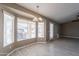 Dining area features laminate flooring, large windows, and modern chandelier at 4873 E Magnus Dr, San Tan Valley, AZ 85140