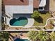 Aerial view of a backyard featuring a uniquely shaped pool, patio, and well-maintained lawn at 5202 E Marconi Ave, Scottsdale, AZ 85254
