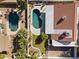 This aerial view shows a private backyard with a pool, surrounded by lush trees and residential homes at 5202 E Marconi Ave, Scottsdale, AZ 85254