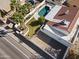 The home's backyard includes a refreshing pool, a grassy area, and a low-maintenance gravel space, all secured by privacy walls at 5202 E Marconi Ave, Scottsdale, AZ 85254
