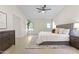 Bedroom featuring tile floors, ceiling fan, dresser, and comfortable queen bed at 5202 E Marconi Ave, Scottsdale, AZ 85254