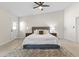 Comfortable bedroom with neutral tones, ceiling fan, and a door to the exterior at 5202 E Marconi Ave, Scottsdale, AZ 85254