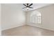 Serene bedroom with a modern ceiling fan and stylish window shutters at 5202 E Marconi Ave, Scottsdale, AZ 85254