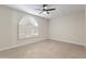 Bright bedroom with a modern ceiling fan and stylish window shutters at 5202 E Marconi Ave, Scottsdale, AZ 85254