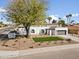 This home boasts desert landscaping, an artificial lawn, and a two-car garage, set against a sunny neighborhood backdrop at 5202 E Marconi Ave, Scottsdale, AZ 85254