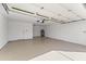 Clean, empty two-car garage with epoxy floor, utility door and water heater at 5202 E Marconi Ave, Scottsdale, AZ 85254