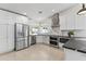 Bright kitchen with stainless steel appliances, white cabinets, and marble backsplash at 5202 E Marconi Ave, Scottsdale, AZ 85254