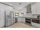 Bright kitchen with stainless steel appliances, white cabinets, and marble backsplash at 5202 E Marconi Ave, Scottsdale, AZ 85254