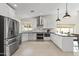Well-appointed kitchen with sleek stainless steel appliances and stylish white cabinetry at 5202 E Marconi Ave, Scottsdale, AZ 85254