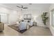 Bright living room with neutral tones, ceiling fan, and comfortable seating arrangement at 5202 E Marconi Ave, Scottsdale, AZ 85254