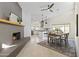 Open-concept living space featuring a cozy fireplace and adjacent modern kitchen at 5202 E Marconi Ave, Scottsdale, AZ 85254