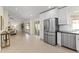 Open-concept living space featuring stainless steel appliances and sliding glass doors at 5202 E Marconi Ave, Scottsdale, AZ 85254
