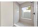 Bright tiled shower featuring natural light from the glass window at 5202 E Marconi Ave, Scottsdale, AZ 85254