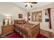 Comfortable bedroom features a wood-look floor, ceiling fan, and shuttered window allowing natural light at 5370 S Desert Dawn Dr # 39, Gold Canyon, AZ 85118