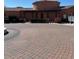 Charming exterior view of a community building with a circular brick driveway at 5370 S Desert Dawn Dr # 39, Gold Canyon, AZ 85118